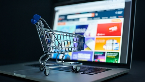 Small,Shopping,Cart,On,A,Laptop,Keyboard,Signifies,Convenience,In
